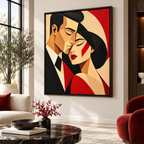Red and black geometric couple canvas wall art in an espresso frame beside a red armchair