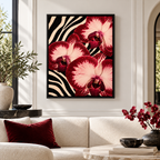 Red orchid zebra print canvas wall art in a black frame above a sofa with burgundy cushions