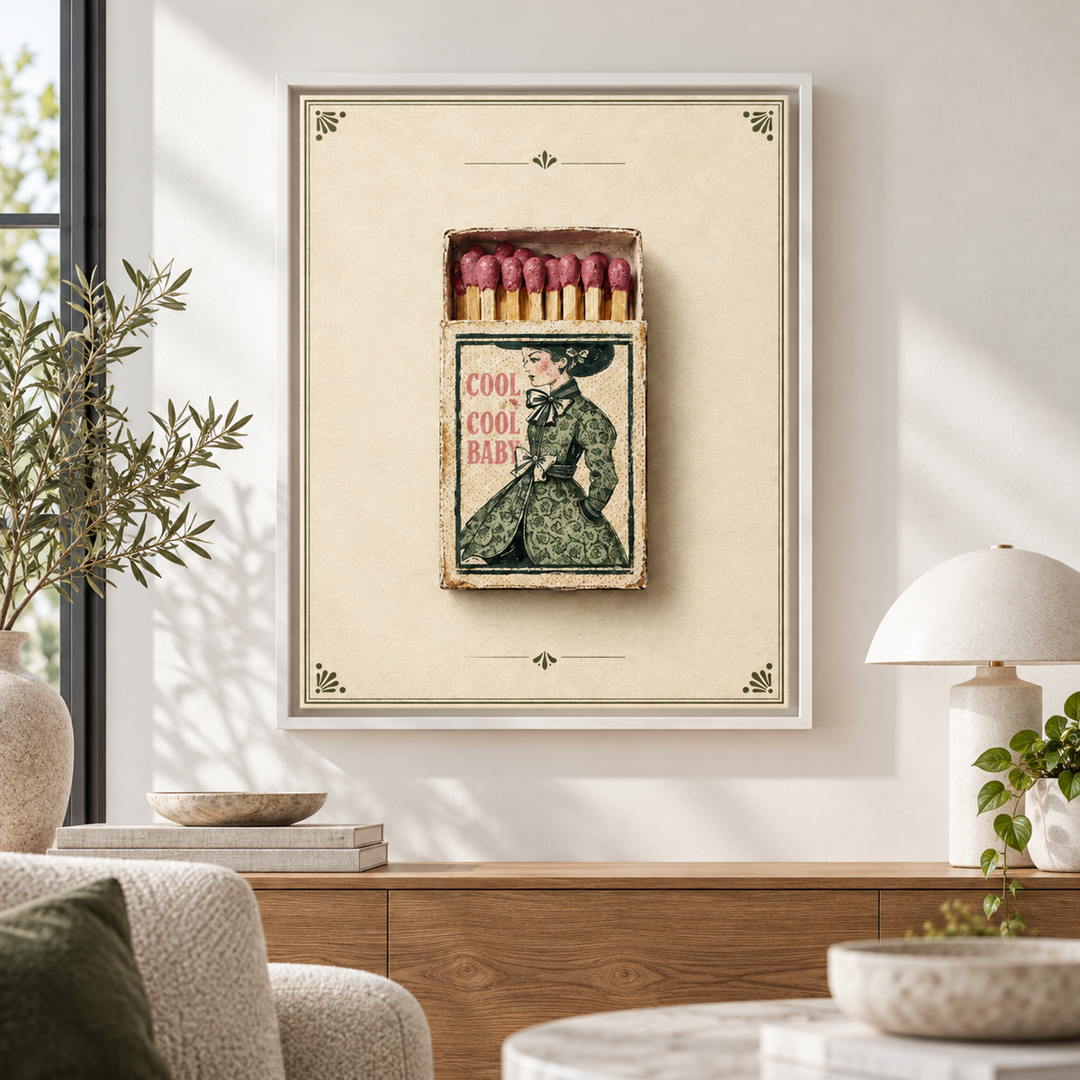 Vintage woman matchbox canvas wall art in a white frame above a wooden sideboard