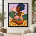 Woman with pink lotus flowers canvas wall art in a black frame above a cream armchair